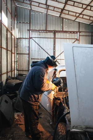 Service station for old damaged automobile. Bodywork and restore body and engine compartment. Workshop backgroundの写真素材