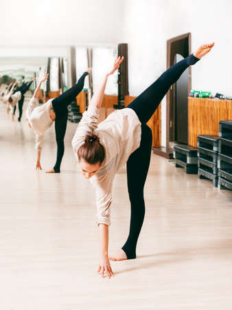 pretty young girl dancing contemporary dance in the gym aloneの写真素材