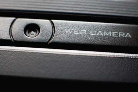 Web camera close up on black laptop monitor. Spy camera (phishing, hack) concept