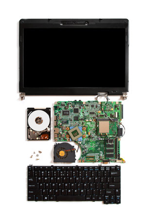 Disassembled open computer isolated on white with electronic parts: motherboard, hdd, keyboard,...