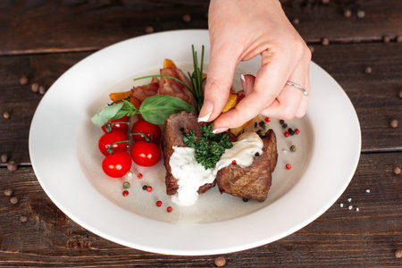 Food decoration on wooden table. Chief presents medium rare pork steak . Food decoration pork steak...