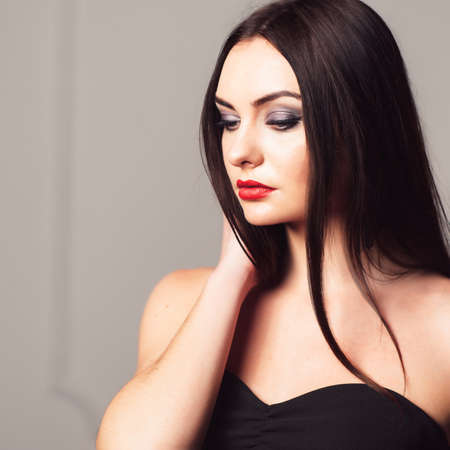 Young attractive woman with bright creative make-up. Sexy girl with creative make-up. Studio shoot of thoughtfull brunette.の写真素材