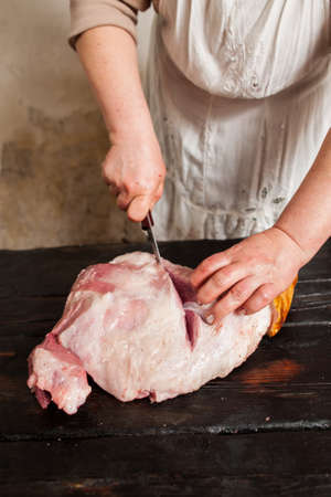 Slicing raw pork meat on piece in farm market.  Butcher slicing raw pork meat in local market. Top viewの写真素材