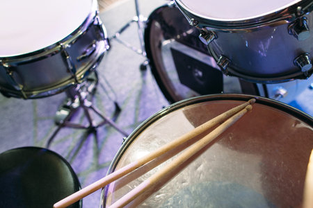 Modern drum set and drumsticks prepared for playing background top view. Flat lay professional drum kit  before a live concert. Drummer, music band, night show, sound recording conceptの写真素材
