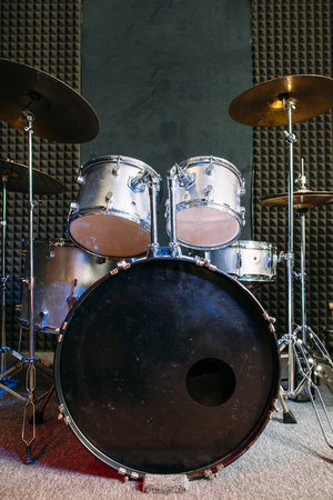 Modern drum set on black stage background prepared for playing. Professional drum kit with some cymbals on stage before a live concert. Drummer, music band, night show, sound recording conceptの写真素材