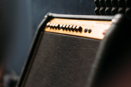 Electric guitar amplifier closep. Selective focus technique on black professional guitar amplifier