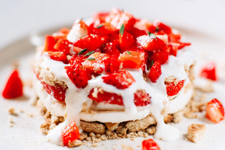Layered cake with fresh strawberry close-up. Delicious cake with fresh strawberry pieces and cream...