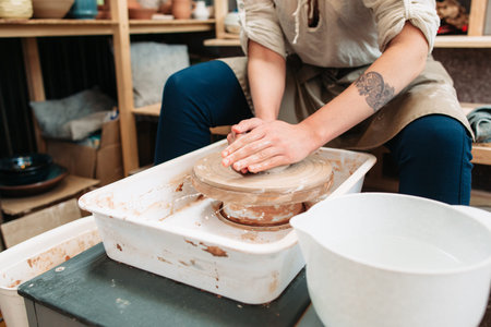 Pottery making art therapy process front view. Picture of female potter who molds some pottery on...