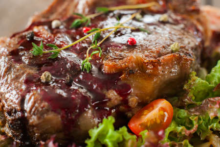 Fried pork steak with red topping, lettuce and tomato close-upの写真素材