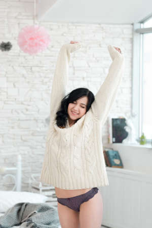 Woman Stretching Happy Smile Bedroom Satisfaction Conceptの写真素材
