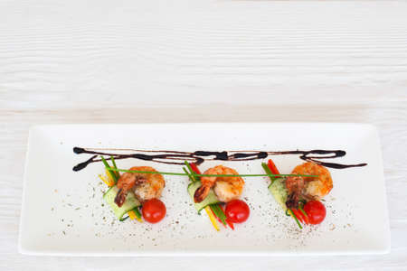 Fried shrimps restaurant serving flat lay, copyspace on white wooden background, horizontal orientationの写真素材