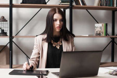 Impressed businesswoman looking at laptop screen. Shocking, unexpected, breaking news, bad surprise, problems, failure, computer virus or deadline concept.の写真素材