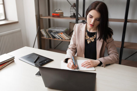 Female cartoonist drawing at office. Creative woman illustrator designing new sketchの写真素材