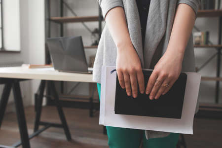 Woman planning vacation, self-development concept. Female manager dreaming about summer rest and write trip plans into notebookの写真素材