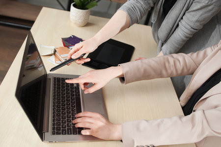Coworking process, designers teamwork in modern office. Creative manager showing new start up idea on monitor.の写真素材