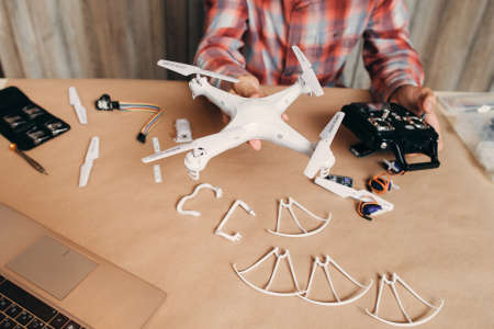 Assembled drone in male hands, diy aero model. Ready for use quadrocopter with some elements of it. Modern technologies, innovation, hobby, aeromodelling conceptの写真素材