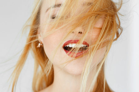 Enjoying something red-haired woman, close up. Portrait of carroty female adult with closed eyes. Seduction, satisfaction, orgasm, sexual arousal conceptの写真素材