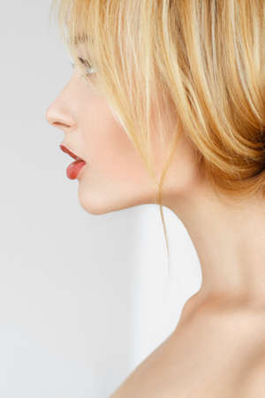 Close-up profile of redhead woman. Beautiful attractive girl with freckles and healthy glow skin side view portrait.の写真素材