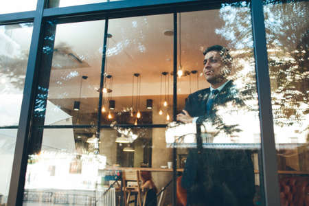 Successful ceo looking through window. Life and work. Achievement and luck concept.の写真素材