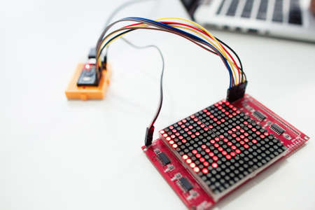 LED matrix display with words hello world. Electronic components for construction on white background, close-up. Technology, hobby, invention conceptの写真素材