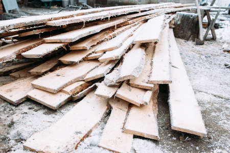 Bunch of boards covered with snow. Frosted wooden planks left outside in winter. Cold, early frosts, hoar conceptの写真素材