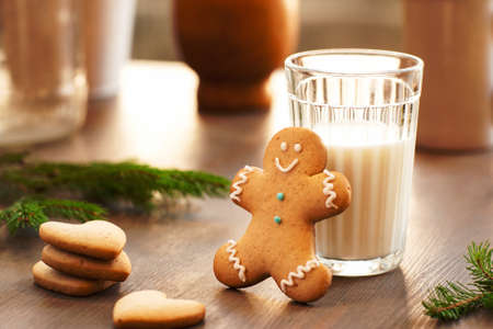 Homemade cookies for the feast of Santa Claus . Glass of milk and gingerbread man waiting for Christmas night. Sweets, xmas, new year conceptの写真素材