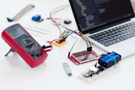 Close-up of multimeter connected with led matrix display. Programmer testing new electronic component. Electronics development, construction, engineering conceptの写真素材