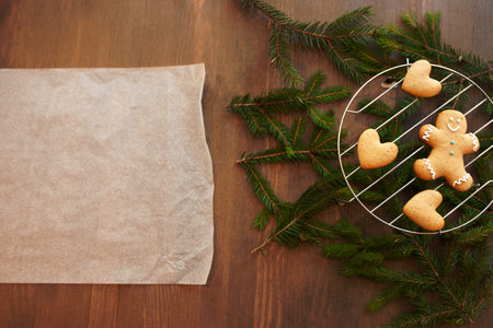 Blank culinary parchment with gingerbread cookies. Christmas culinary composition with pine-tree and...