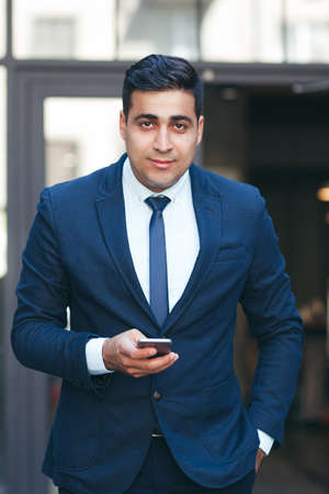 Successful rich businessman outdoors. Handsome businesslike man in suit. Careerist and workaholic.の写真素材