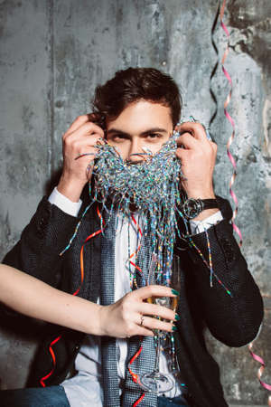 Man at party refuses to drink champagne on gray background. Building drink refusal skills. New year alcohol denialの写真素材