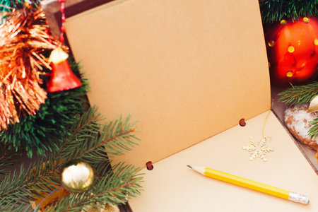 Empty brown sketchbook with Christmas decorations, free space for text, sketch or advertisement. Winter holidays elements. Inspiration of Xmas spiritの写真素材