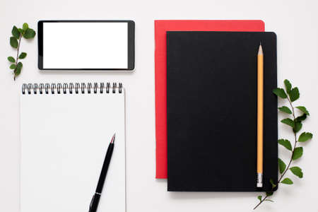 Blank notepad and smartphone screen with supplies. Free space for text, set of work tools of modern office manager. Business, technology, mockup conceptの写真素材