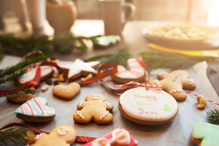 Traditional Christmas cookies on kitchen table. Active preparing for winter holidays, xmas spirit, culinary, home conceptの写真素材