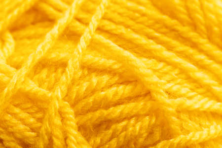 Yellow knitting thread texture, handiwork backdrop. Bright handiwork background, crochet woolen string, Leisure, hobby, needlework conceptの写真素材