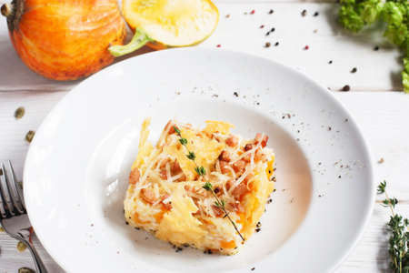 Rice casserole in cheese basket on plate. Tasty baked mix of rice and pumpkin with cheese. Restaurant food, seasonal menu, autumn cuisine conceptの写真素材