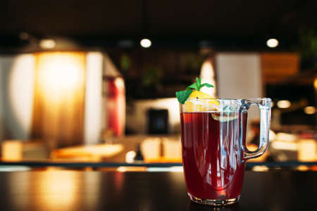Glass of tasty red punch on restaurant table. Sangria wine with orange slice. Bar, party, recipe, refreshment, winter beverage conceptの写真素材