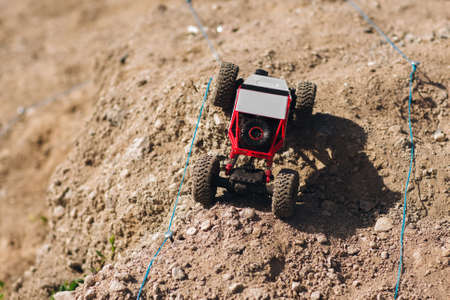 Toy buggy car racing on rally track. Rc crawler roading on dry desert landscape background. Hobby, entertainment, race , competition conceptの写真素材