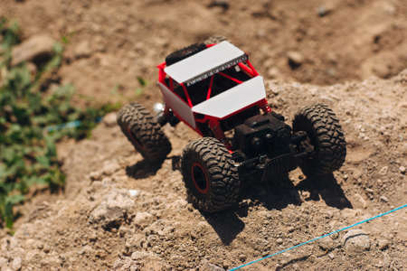 Buggy car riding in desert, free space. Toy rc suv driving through dry landscape. Extreme sport, rally, leisure conceptの写真素材