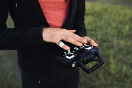 Man touching remote controller close-up, free space. Unrecognizable blind studying transmitter before piloting vehicle. Touch, modern technologies, life, leisure conceptの写真素材