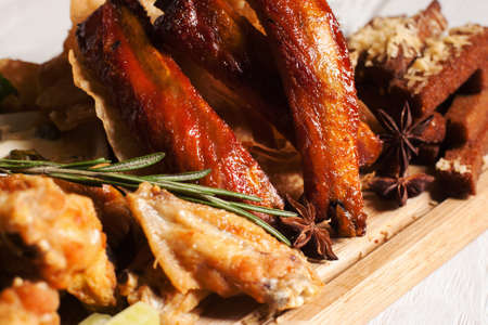 Close-up of smoked delicious snacks. Tasty golden appetizing assortment of junk food. Fat, american cuisine conceptの写真素材