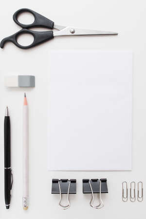 Blank card with craft tools flat lay mockup. Top view on white and black stationery set. Business, art, education, office supplies, design conceptの写真素材