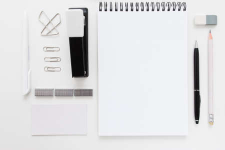 Black and white stationery set free space flat lay. Top view on white desk with office supplies, mockup. Business, worktools, education, accessories conceptの写真素材