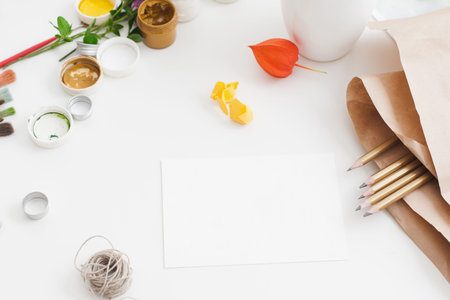 Blank card with craft tools free space. Artist workplace with instruments for handmade greeting card creation, gouache and set of pencils. Art, creativity, imagination, inspiration, hobby conceptの写真素材