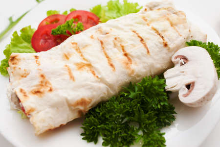 Burrito with fresh mushroom and parsley close up. Grilled shawarma served with vegetables. Turkish sandwich, mediterranean cuisine, junk food conceptの写真素材
