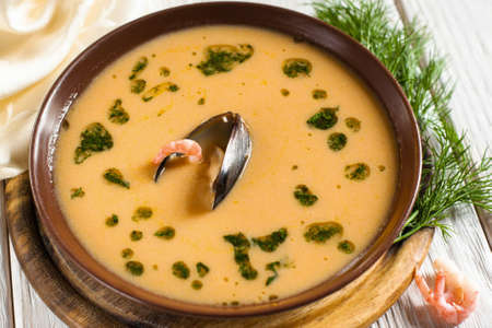 Plate with soup with shrimp and mussel. Top view on traditional cream soup with seafood. Mediterranean cuisine, restaurant food, menu conceptの写真素材