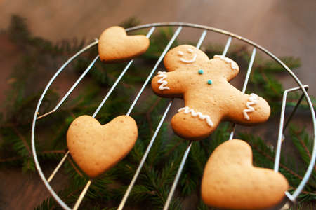 Sweet gingerbread hearts with man on grill. Homemade preparing of pastry for Valentine holiday. Family, love, surprise, pastry conceptの写真素材