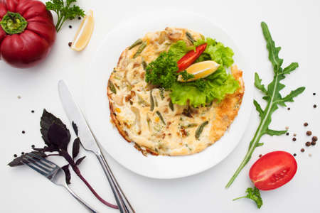 Omelet with mushrooms and basil flat lay. Top view on dish with scrambled eggs with vegetables and cutlery, free space. Breakfast, healthy food, morning meal conceptの写真素材