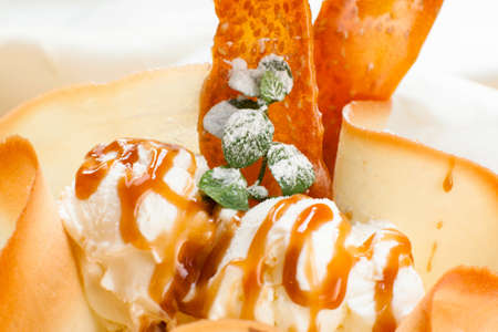 Ice-cream with caramel topping and waffle close-up. Delicious sweet dessert background. Sweet food, refreshing, restaurant menu conceptの写真素材