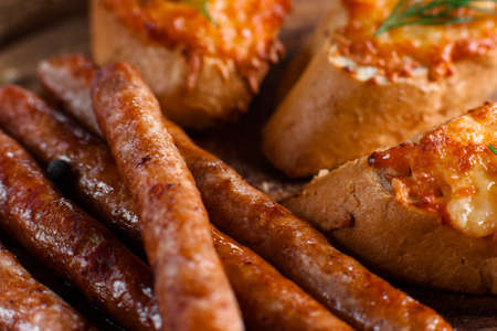 Bavarian sausages with canapes closeup. Appetizing fat snack for beer background. German cuisine, junk food, dieting conceptの写真素材