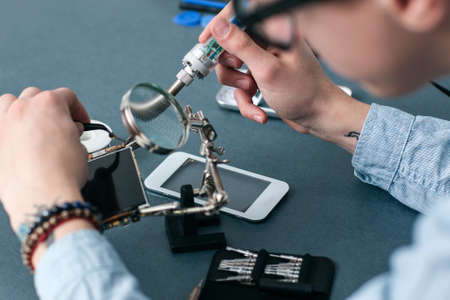 Smartphone Repair Shop Electronic Technology Business Communication Fix Conceptの写真素材